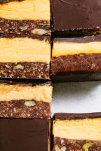 Close up of several nanaimo bars showing the layers.