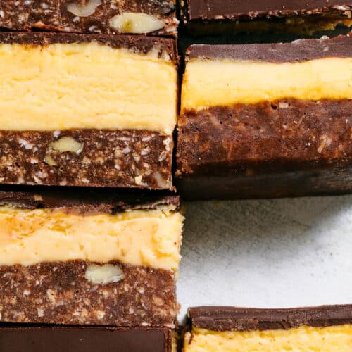 Close up of several nanaimo bars showing the layers.