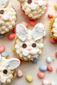 Easter bunny face cupcakes made from white frosting and marshmallow ears.