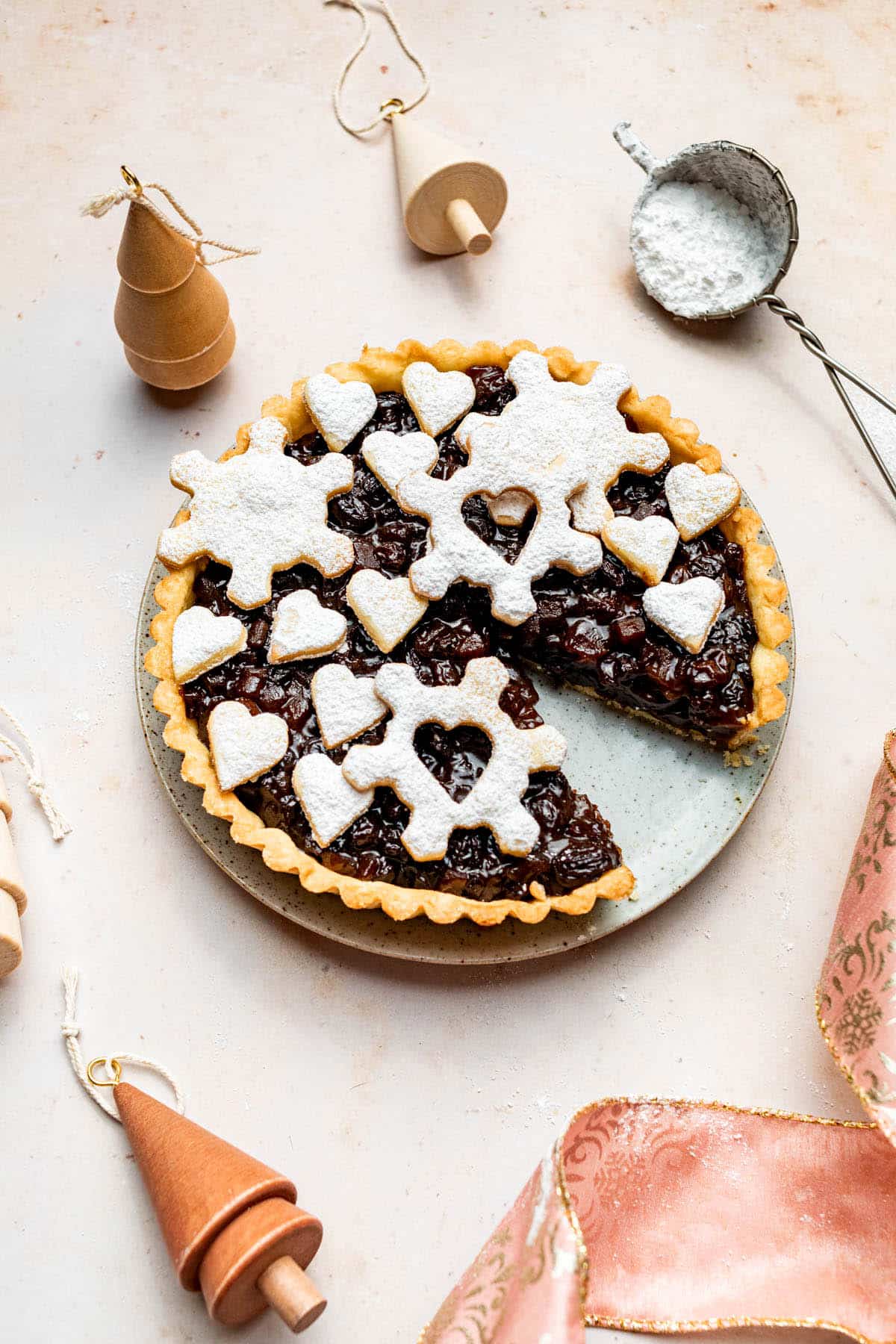 A large mincemeat-filled pie topped with pie crust snowflakes and hearts.
