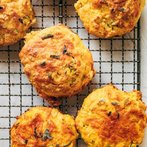Onion-topped pumpkin biscuits on a wire rack.