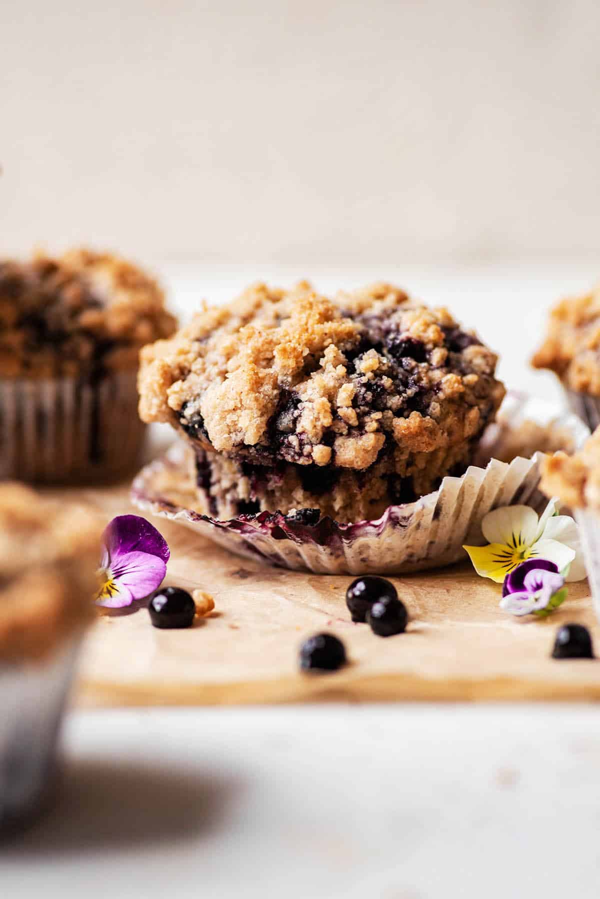 Streusel-topped blueberry muffin with the liner removed.