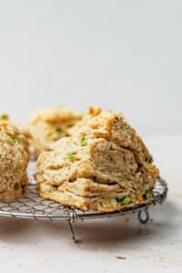 Close up of vegan biscuits on a round wire rack.