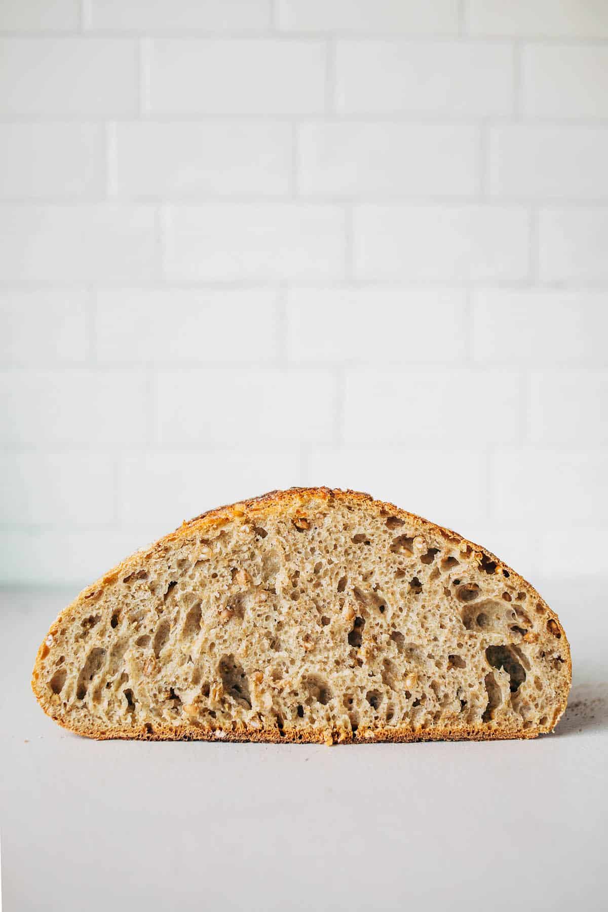 A loaf of sourdough bread, halved to show the interior crumb.