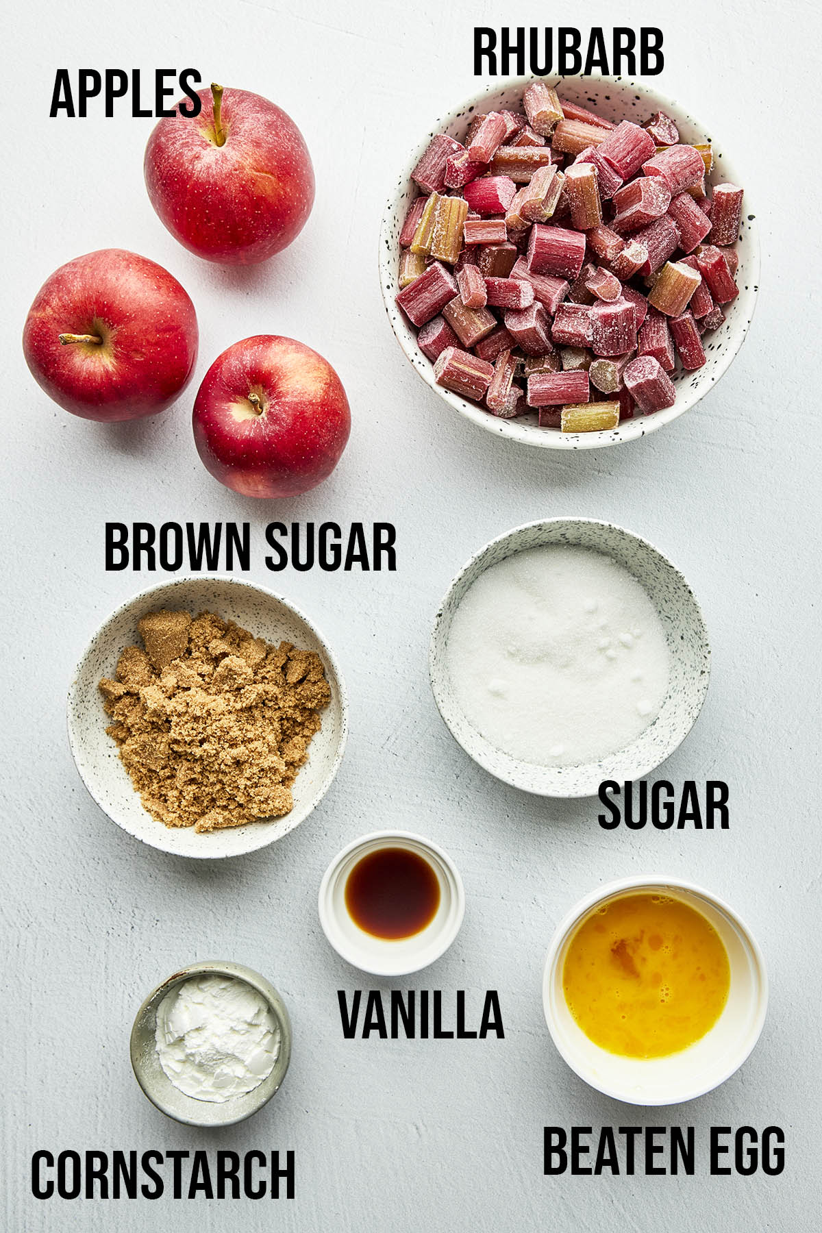 Apple rhubarb pie ingredients with labels.