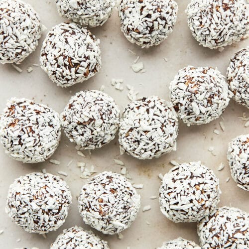 Top-down view of several coconut-rolled chocolate balls.