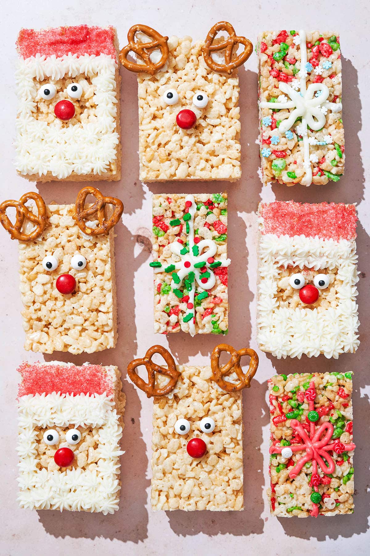 Nine holiday-decorated rice krispie treats, top down view.