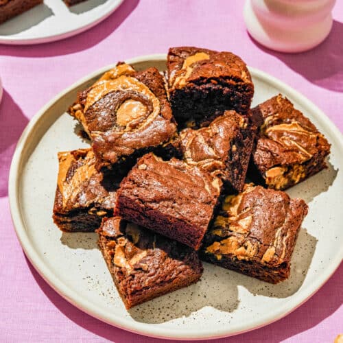 A plate full of brownies swirled through with peanut butter.