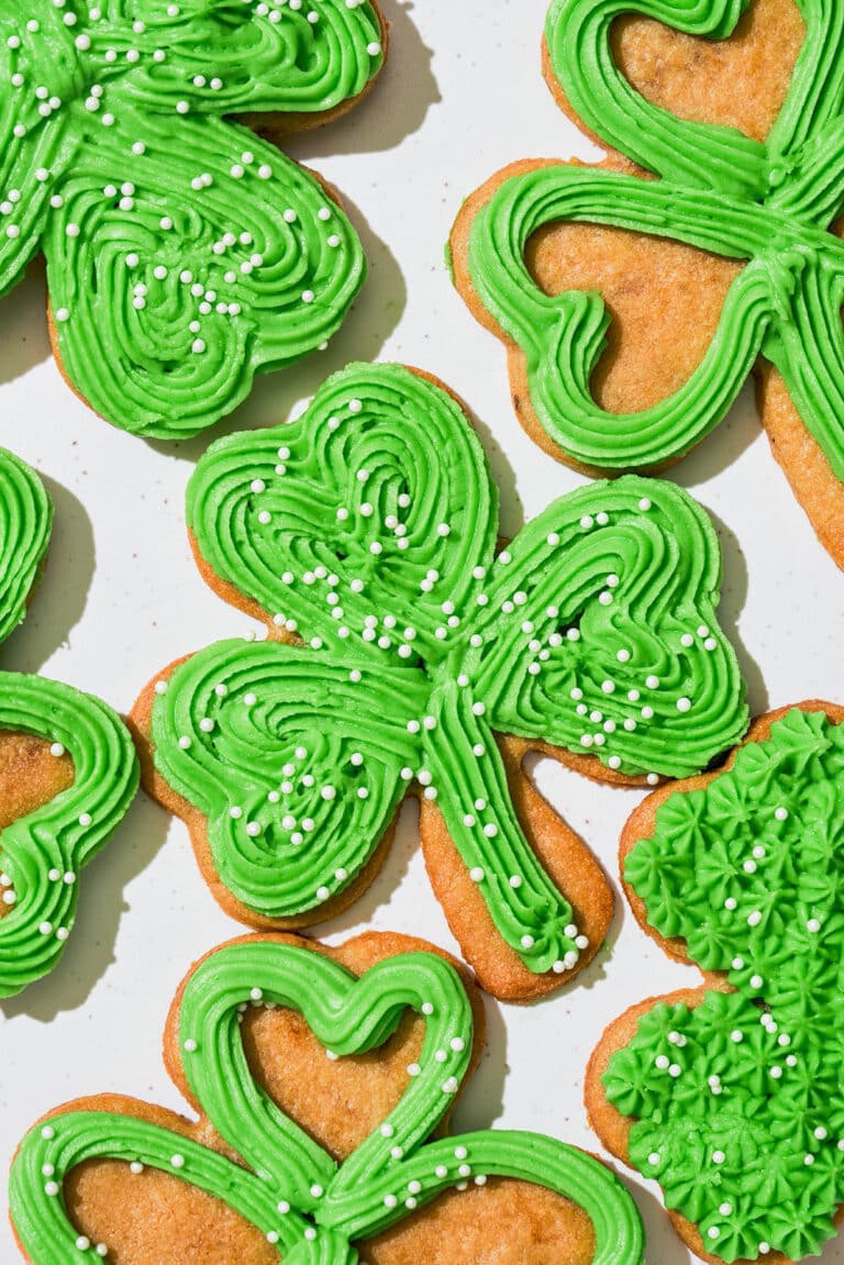 Close up of green-frosted clover cookies.