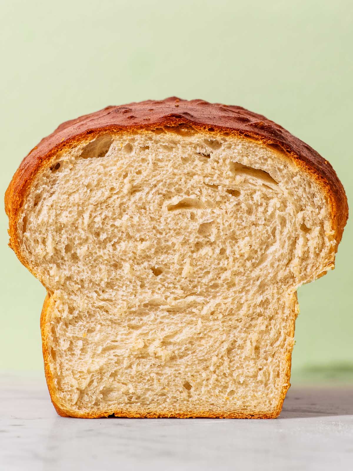 Close up of a halved loaf of bread showing the interior texture.