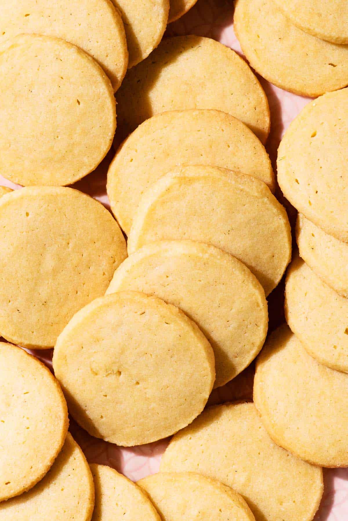 Several small round cookies in fallen rows on a platter.