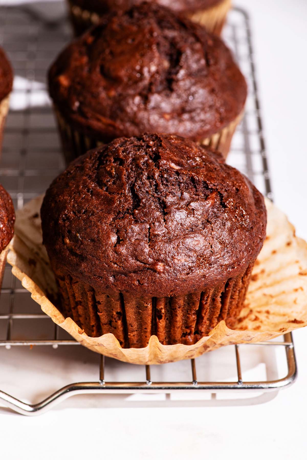 Close up of muffins on a wire rack.