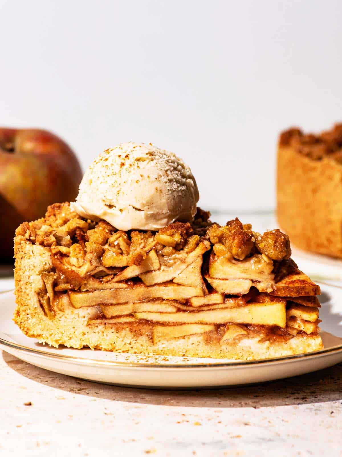 Slice of apple pie with a scoop of ice cream on top.