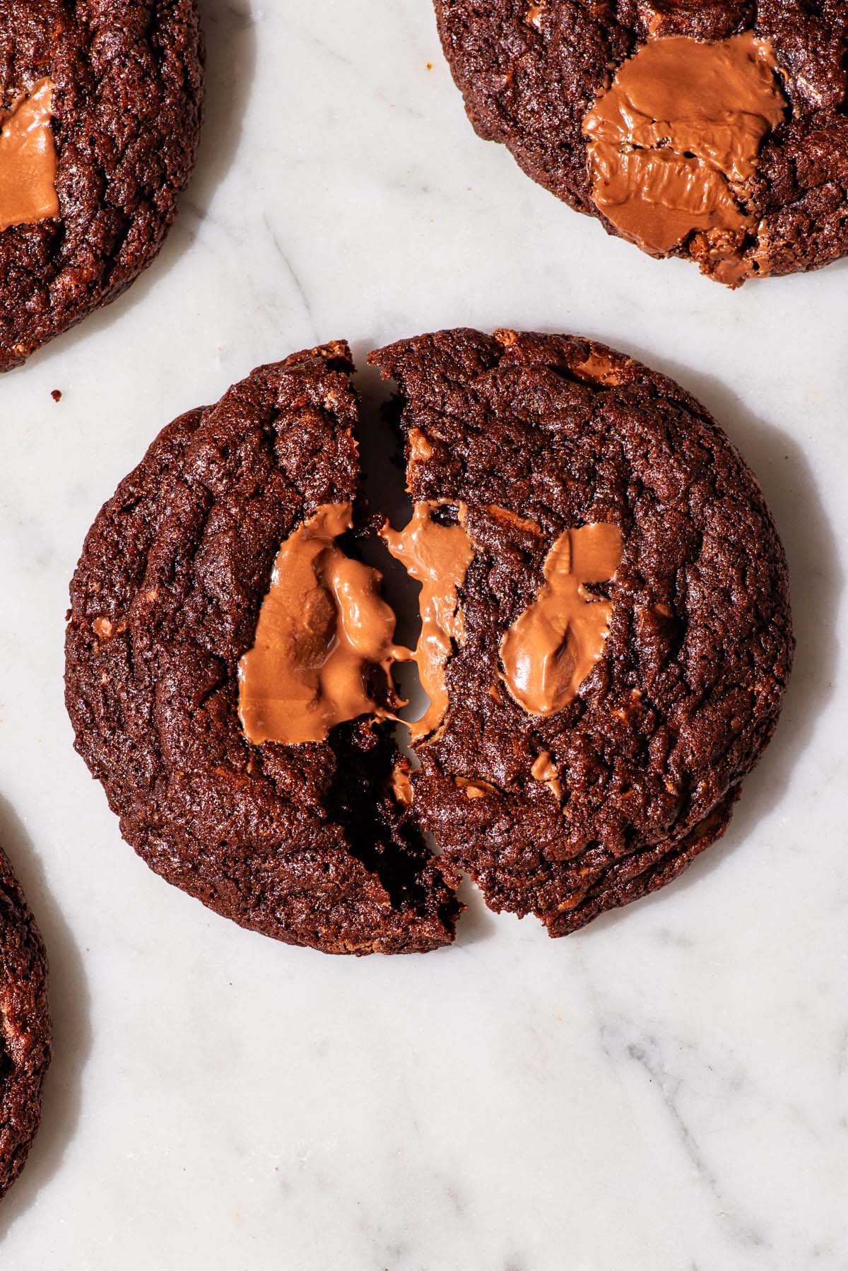 Chocolate cookies, one broken in half.